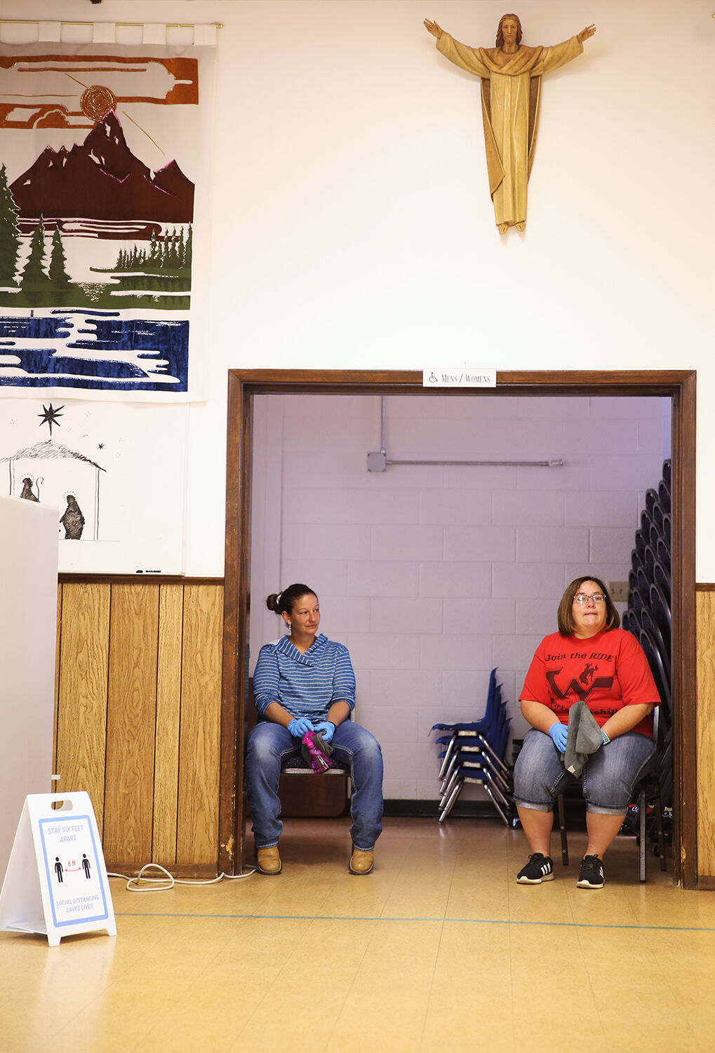 Tanna Nielsen, left, and Shannon Sickler take a break from sanitizing